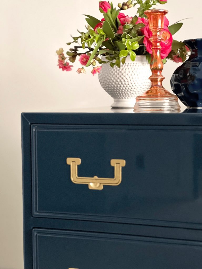 Navy blue dresser with ornaments