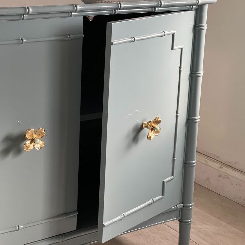 self-closing gray cabinet with flower knobs