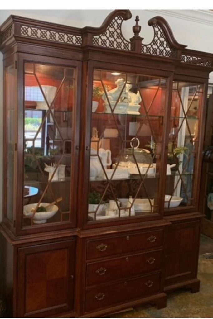 Brown china cabinet with fretwork crown