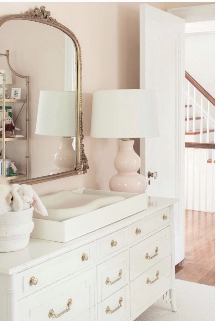 Blush pink nursery with vintage faux bamboo dresser