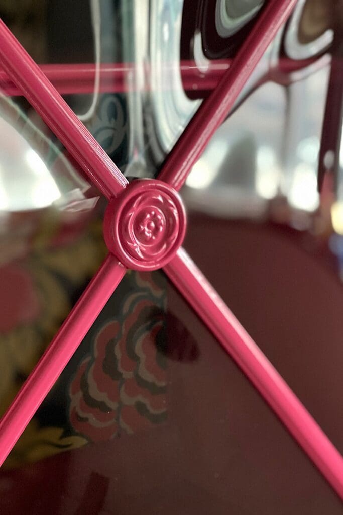 Floral rosette detail on china cabinet 