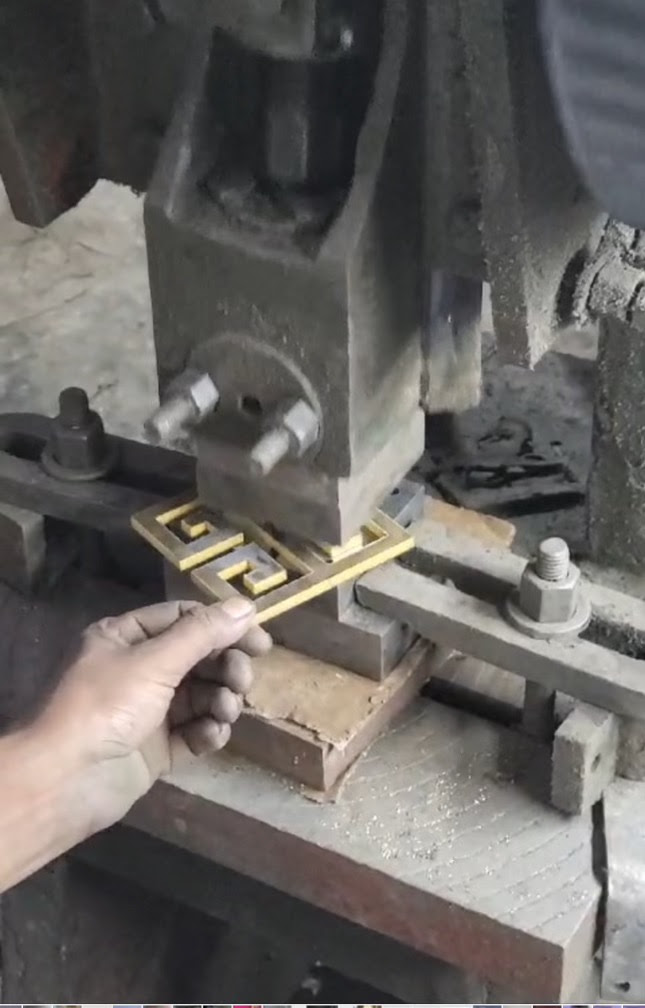 Hardware being pressed by machine